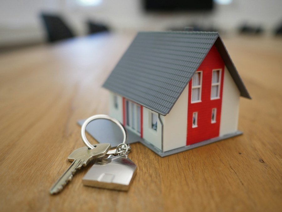 House keys and a small model home representing a property transaction